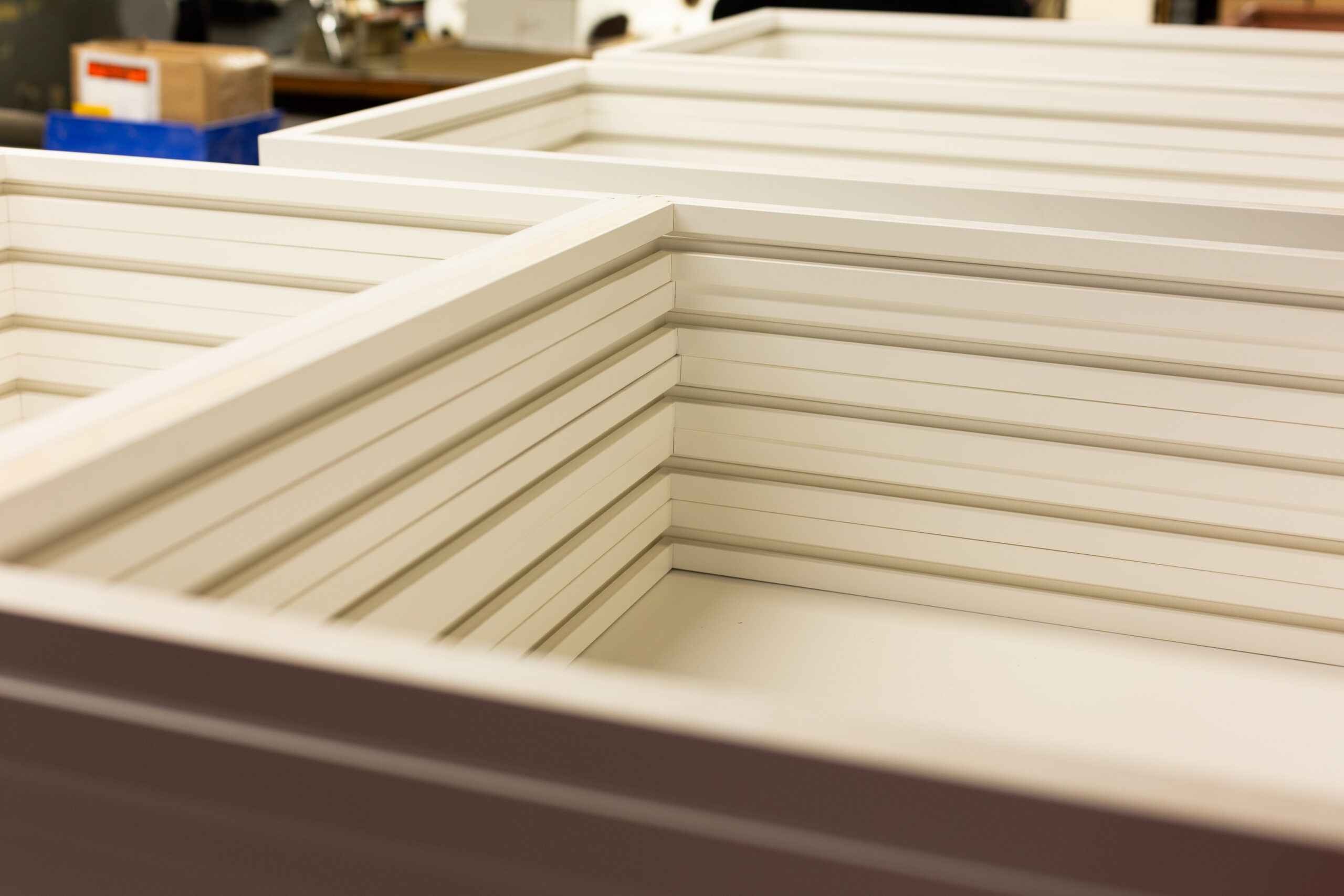 An example of Peterson Picture Co.'s frames order in bulk - perfectly sized modern white frames ready to be packed and delivered.