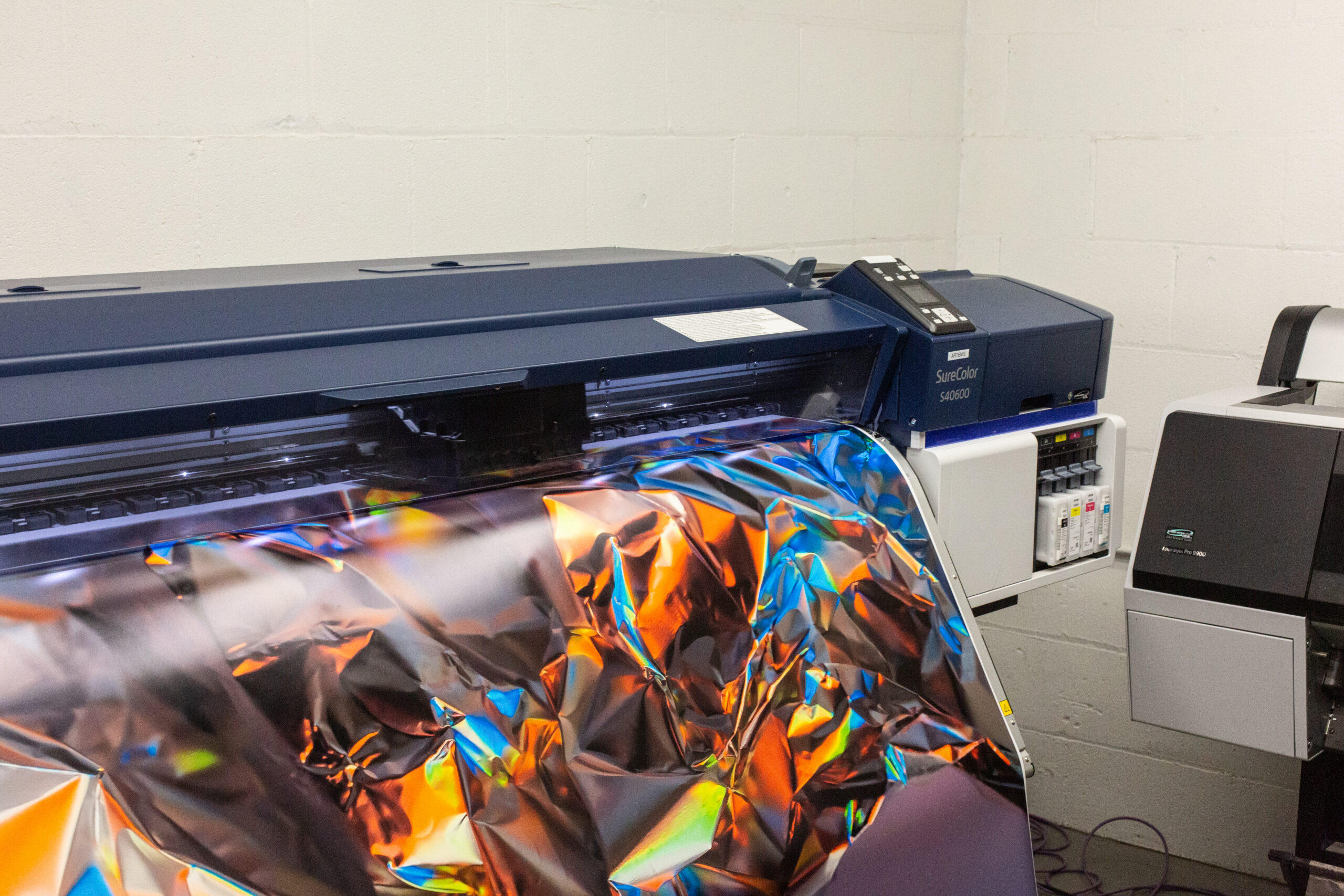 The Epson SureColor 40600 is in use for printing. It can print vivid imagery on a durable canvas substrate up to 58” on the shortest side.