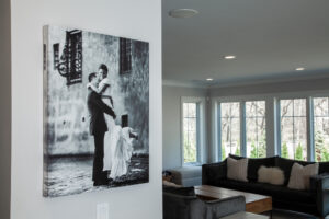 Residential project by Peterson Picture Framing Company - A zoomed-out image of a residential room with a large black-and-white photograph of a couple on their wedding day is framed and hung on the wall.